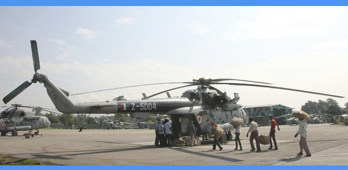 Labourers load relief goods for flood victims onto an Indian Air Forceu2019s helicopter at an airport in Jammu yesterday.