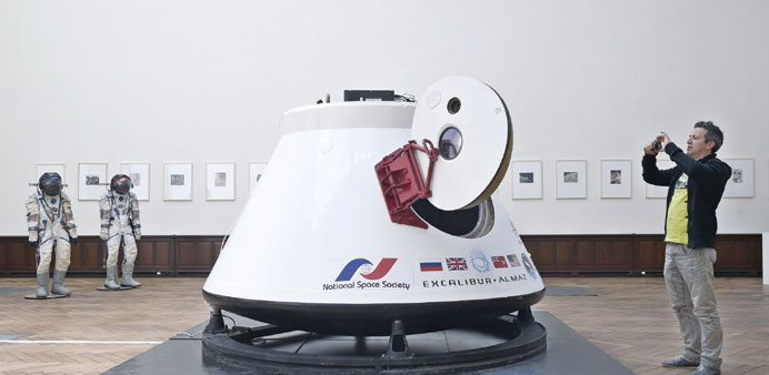 A man takes a picture of the Soviet space capsule Vozvrashchayemi, on May 5 ahead of its auction.