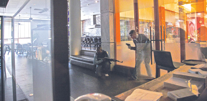 Armed men checking a cafeteria inside the Westgate shopping mall after a shootout in Nairobi, Kenya. Kenyan security forces managed to rescue more hos
