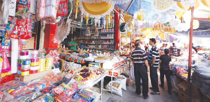 Men gather at a market in Baghdad on Sunday.