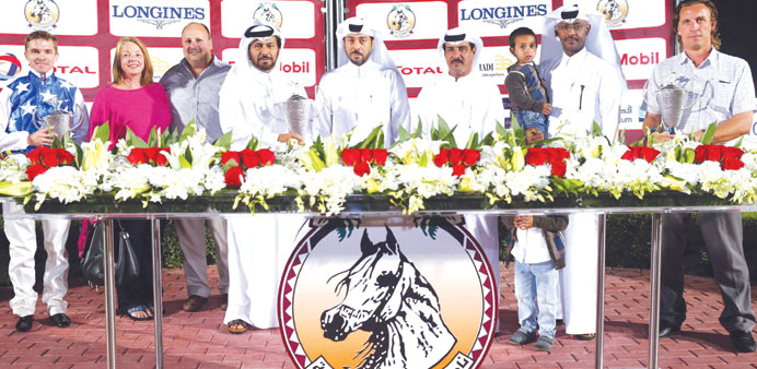 Board Member Mohamed Ali al-Sheeb is seen with the winners of the Britha Cup at the Qatar Racing and Equestrian Club yesterday. PICTURES: Juhaim