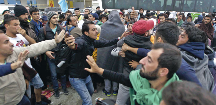 Migrants fight over who first boards the buses which will bring them to a train station in Austria, near the town of Hegyeshalom, Hungary, yesterday.