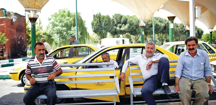 Taxi drivers wait for passengers at Shoosh square in southern Tehran yesterday.