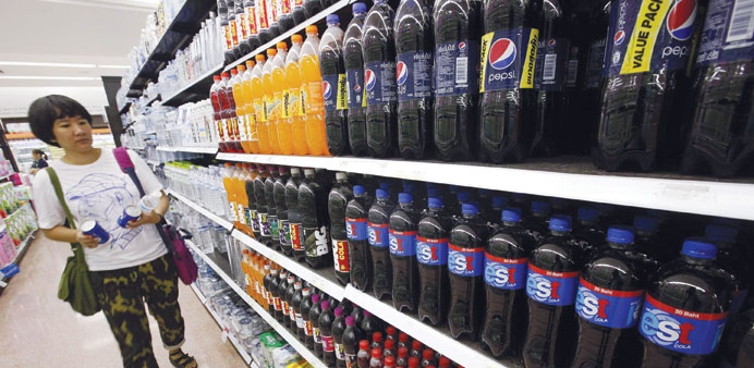 A customer walks past a shelf of soft drinks, including Pepsi and est sodas, in a supermarket in Bangkok (file). Serm Suk, Pepsiu2019s bottler and partner