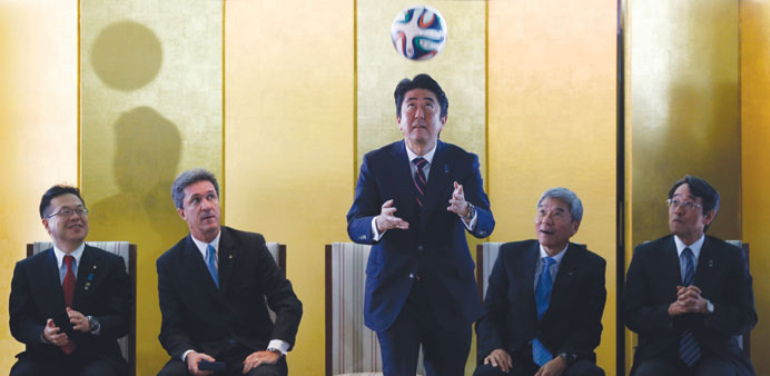 Japanu2019s Prime Minister Shinzo Abe heads the ball during a meeting with Brazilian soccer players in Brasilia yesterday.