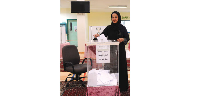 A woman casts her ballot at a polling station in Jeddah yesterday.