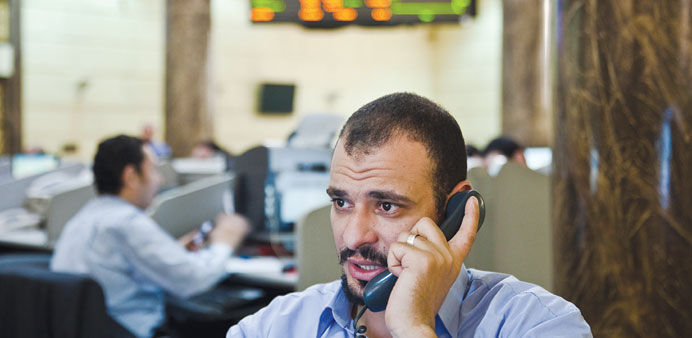 A trader speaks on the telephone while working at the Egypt Stock Exchange in Cairo (file). Egyptu2019s bourse rose yesterday after Gulf countries pledged