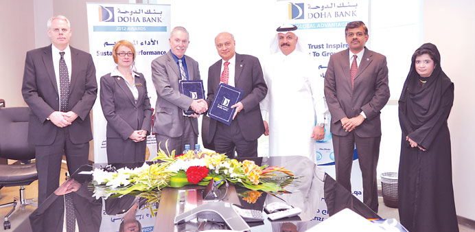 Senior Doha Bank and CNA-Q officials at the signing ceremony.