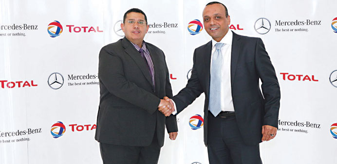 Total and NBK Automobiles officials after signing an agreement.