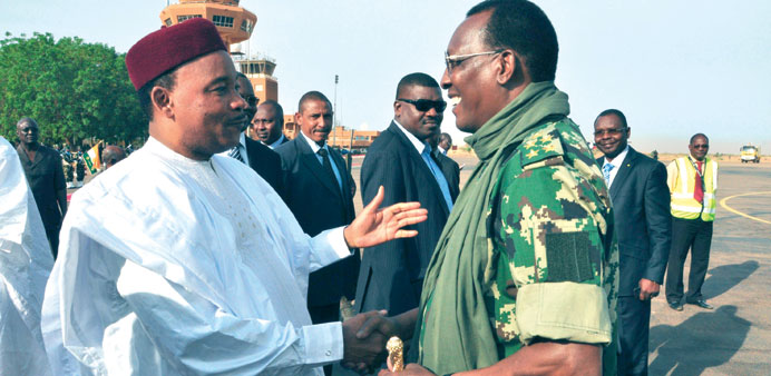 Niger President Mahamadou Issoufou (left) welcomes Chadian President Idriss Deby in Niamey yesterday after Deby visited Chadian soldiers based in a mi