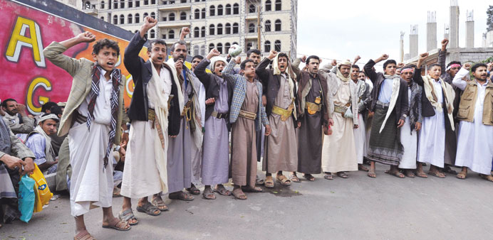 Members of the Shia Houthi movement shout slogans during a rally demanding the dismissal of the government in Sanaa yesterday.