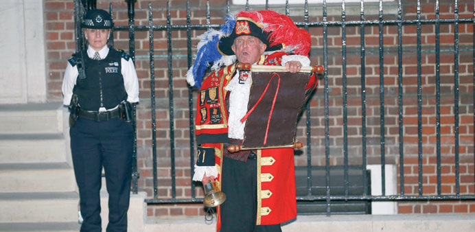 A town crier announcing the royal birth outside the Lindo Wing of St Maryu2019s Hospital in London yesterday.