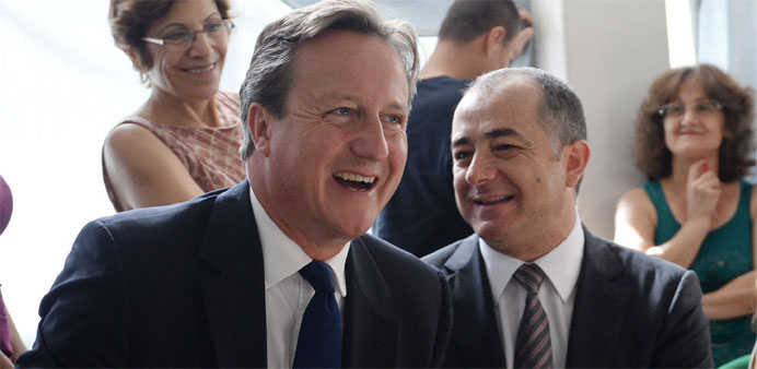 Britain's Prime Minister David Cameron (L) and Lebanese Education Minister Elias Bou Saab 