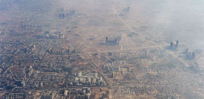 In this photograph taken on November 25, 2014 smog envelops buildings on the outskirts of New Delhi.