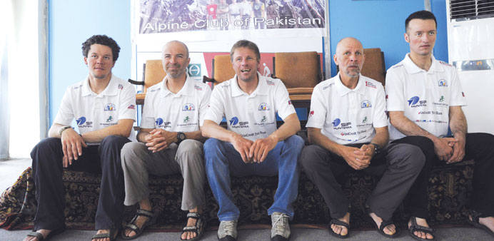 Zsolt Torok, centre, leader of a five-member Romanian mountaineers team, sits with his team as they talk with journalists after scaling the worldu2019s se