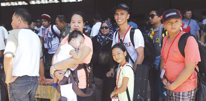 Filipino before boarding a ship as part of an evacuation from conflict-torn Libya.
