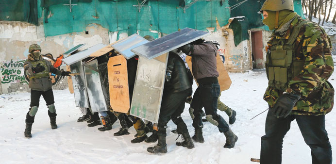 Protesters with shields take part in a training session to learn how to resist riot police, in downtown Kiev.