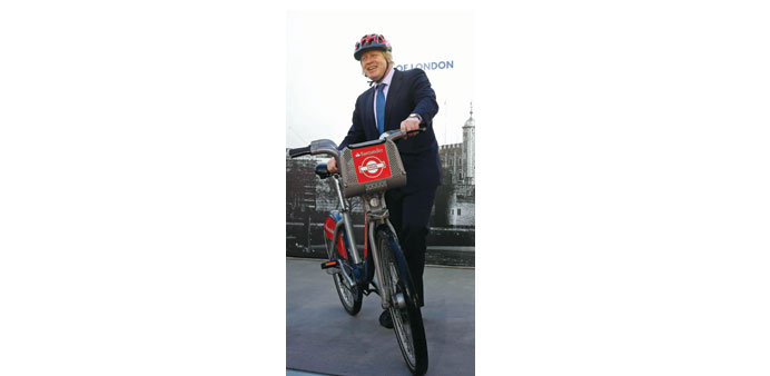 London mayor Boris Johnson poses with a bicycle after announcing Santander as the new sponsor for the London Cycle Hire in London yesterday. 