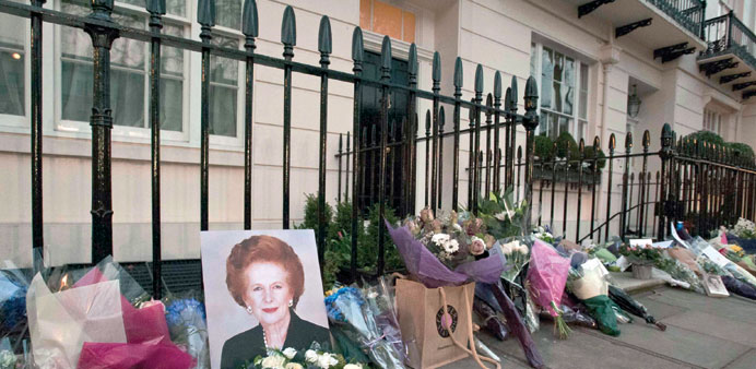    Flowers and mementos left by members of the public and admirers  outside the home of Margaret Thatcher in central London yesterday.
