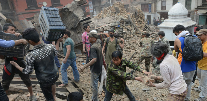 People clear rubble in Kathmandu's Durbar Square, a UNESCO World Heritage Site
