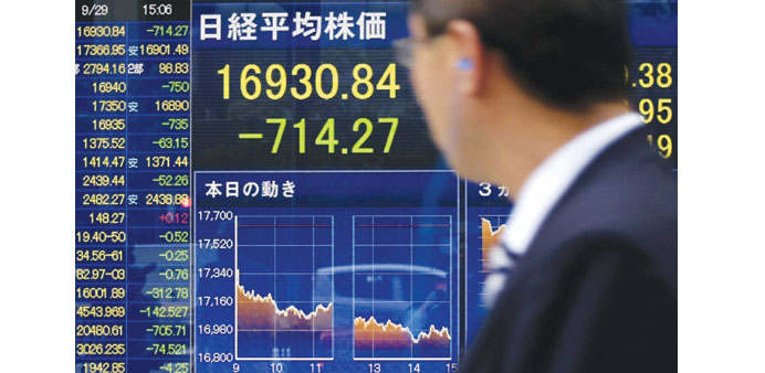 A man looks at a share prices board in Tokyo. Japanese stocks closed down 4.05% yesterday.