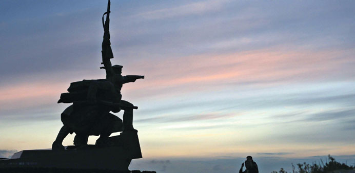 People pass by the Soldier and Sailor monument in the city of Sevastopol in Crimea.