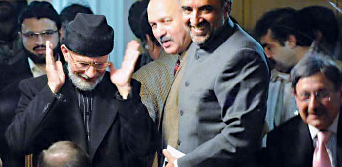 Face-saver: Dr Tahir-ul Qadri, in black coat and cap, left, with the negotiating team during the the Islamabad long march.