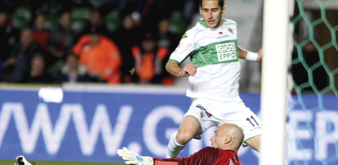 Elcheu2019s striker Botia (back) tries to score in front of Argentinian goalkeeper Willy Caballero of Malaga FC, during their La Liga match in Elche on Fr