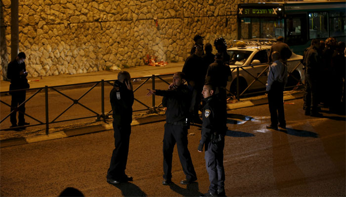 Israeli policemen stand next to the scene of an attack in Jerusalem. Reuters