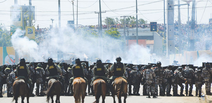 Riot police officers clash with protesters who blocked access to the Castelao Stadium in Fortaleza yesterday.