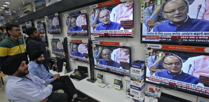People watch television sets displaying India's Finance Minister Arun Jaitley presenting the budget in parliament