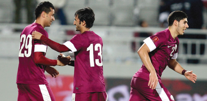 Qataru2019s Boualem Khoukhi is congratulated by a team-mate after he scored a goal against Kuwait during their WAFF Championship semi-final yesterday.
