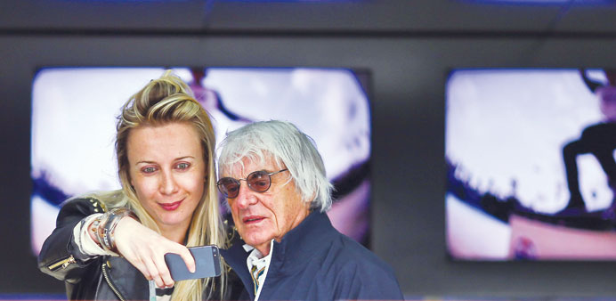 Formula One boss Bernie Ecclestone poses with a spectator at the paddock during the Belgium Grand Prix practice sessions, yesterday. (EPA)