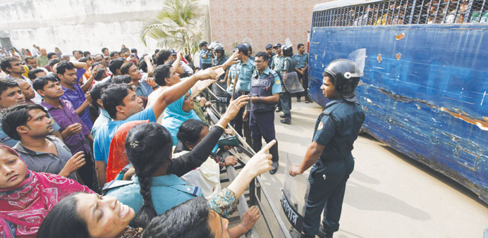 Relatives reacting as a police van carrying prisoners arrived at the gate of the central jail after the verdict of a 2009 mutiny was announced in Dhak