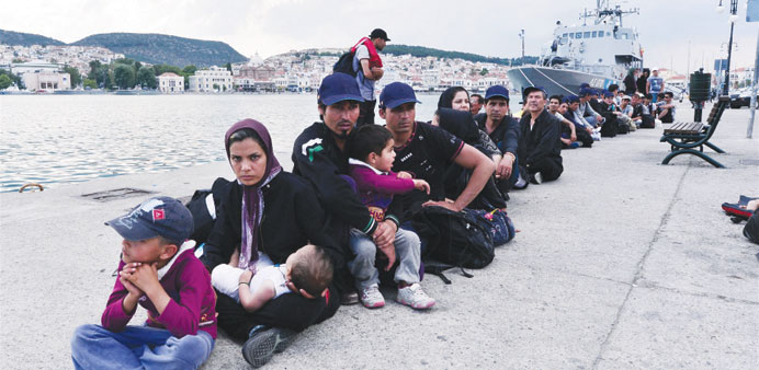 Migrants and asylum seekers queue up at Mytilene Port on Lesvos waiting for police clearance.