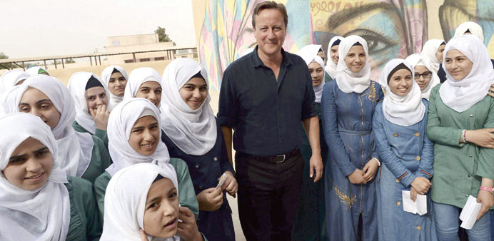 Cameron meets pupils at the Safiyyeh bint Abdel Muttaleb Girls School in the town of Zaatari near Amman yesterday.