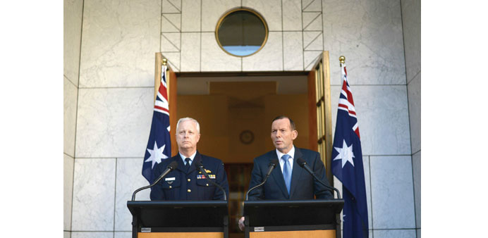 Australian Prime Minister Tony Abbott and Chief of the Defence Force Air Chief Marshal Mark Binskin speak during a press conference at Parliament Hous