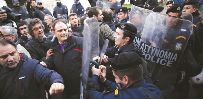 Protesters scuffle with riot police during a rally yesterday against the Greek EU Presidency, in Athens.