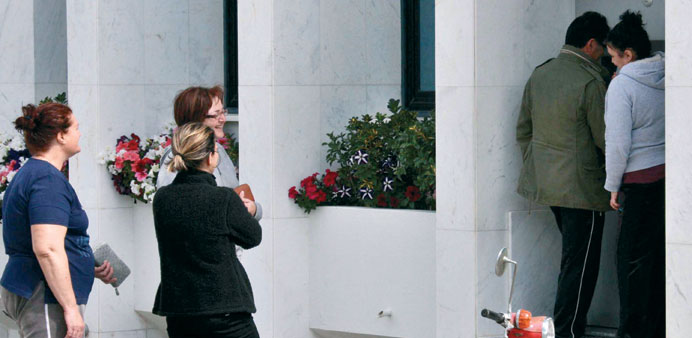People queue up to withdraw money from an ATM in Nicosia, yesterday.