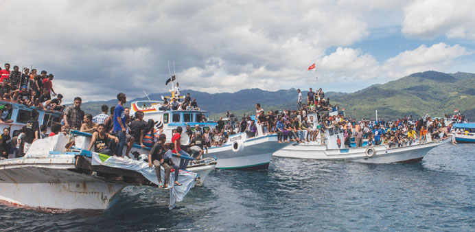    Boats overloaded with Christian devotees participate in a boat procession in the waters of Larantuka, East Nusa Tenggara province, eastern Indonesi
