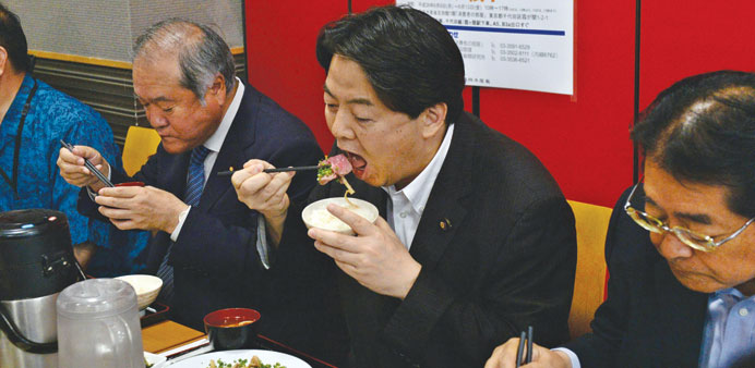 Japanese Agriculture Minister Yoshimasa Hayashi joins Japanese lawmakers for a whale meat promotion at his ministry in Tokyo yesterday.
