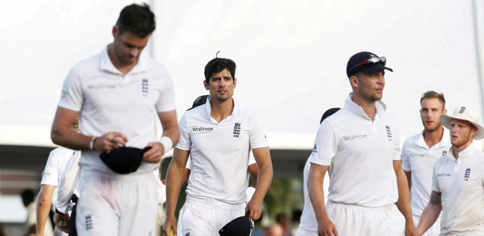 England captain Alastair Cook (centre) and his team look dejected after their defeat to West Indies in the thrid Test. (Reuters)