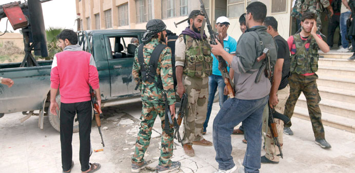 Free Syrian Army fighters prepare themselves yesterday before going to the frontline in Raqqa province, east Syria.