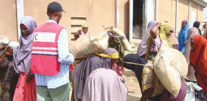 A QRC representative supervising distribution of food items in Somalia.