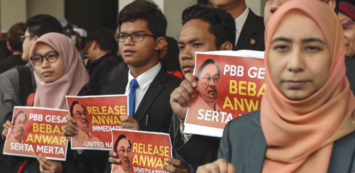 Members of Malaysian opposition hold placards reading u2018Release Anwar immediately!u2019, after a press conference at Parliament House in Kuala Lumpur yeste
