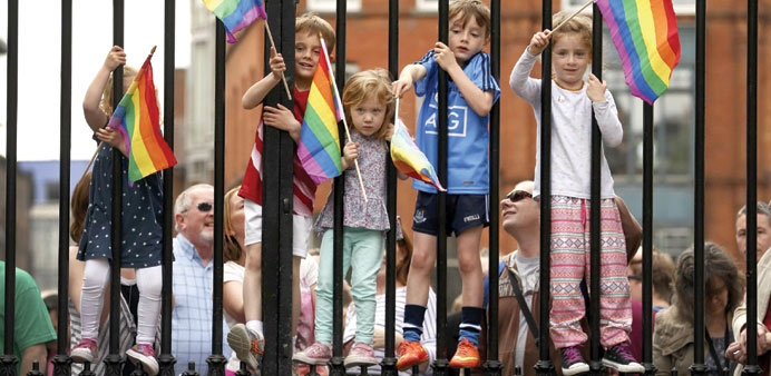 Children wave rainbow flags at Dublin Castle in Ireland yesterday.
