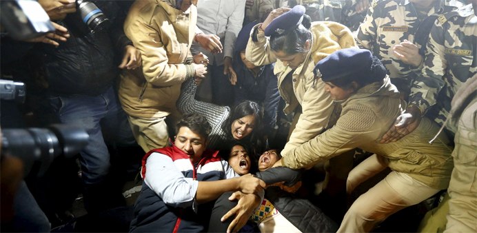 Police detain demonstrators during a protest against the release of a juvenile rape convict, in New Delhi, India
