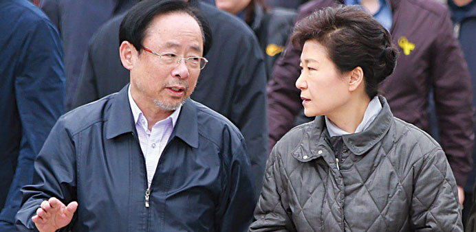 South Korean President Park Geun-hye (right) speaks to Lee Ju-young, the minister of oceans and fisheries, during her visit yesterday to Paengmok Port