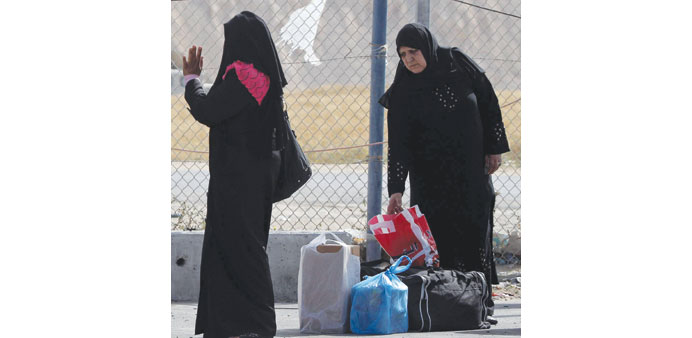 Palestinian women wait at the Rafah crossing with Egypt in the Gaza Strip yesterday.