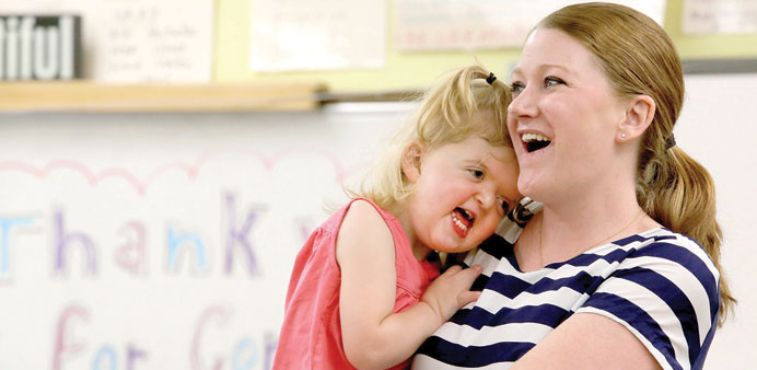 SPECIAL BOND: Kerry Lynch holds her daughter, Mary Cate Lynch, 2, at Oriole Park Elementary School in Chicago to give a disability awareness presentat